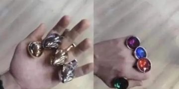 Hand holding toy rings, jokingly called Infinity Stones.