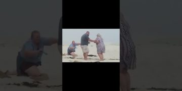 Thumbnail for a funny beach proposal video showing a romantic moment turning into sudden chaos and an awkward fail