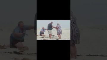 Thumbnail for a funny beach proposal video showing a romantic moment turning into sudden chaos and an awkward fail