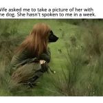 Woman crouching in a field with a dog's face; humorous mix-up.