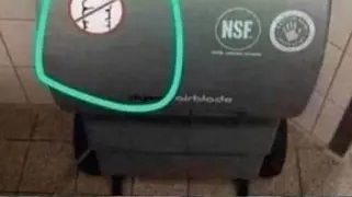 Confused man wondering about Dyson hand dryer instructions.