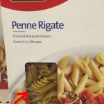 Close-up of penne pasta box showing a different pasta type inside.