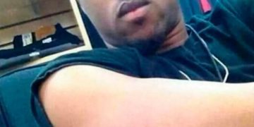 Man shows off his arm with an invisible tattoo of his dad