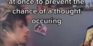 Person multitasking with various media to avoid thinking