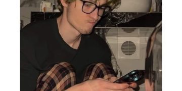 Person reading a message repeatedly, unsure how to reply.