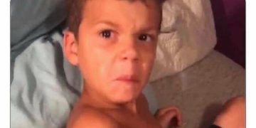 Kid making an annoyed face after being woken up early.