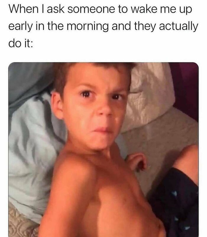 Kid making an annoyed face after being woken up early.