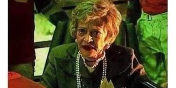 Elderly lady with text: Never trust the living.