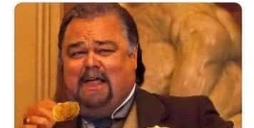 Man humorously eating a chicken nugget, ignoring shared portion size.