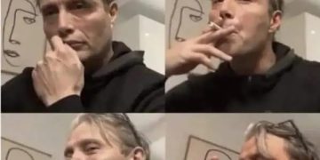 Person celebrates after completing one task from to-do list with drink