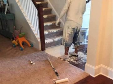 Man accidentally spills white paint everywhere in a staircase mishap.