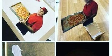 Cardboard cutout pizza prank setup at door