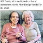 Two elderly women smiling, holding hands in a retirement home.