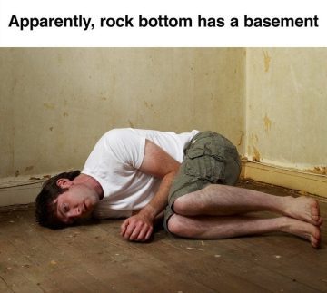 Man lying on the floor in a bare room with text about rock bottom