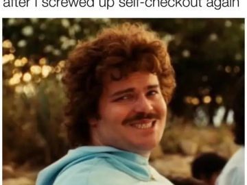 Man waiting awkwardly for help at self-checkout