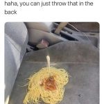 Spaghetti spilled on car seat with a fork sticking out