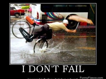 Man hilariously falling off a bike in the rain with an umbrella.