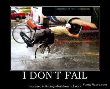 Man hilariously falling off a bike in the rain with an umbrella.