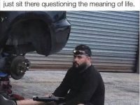 Man sitting in front of car, pondering DIY project gone long