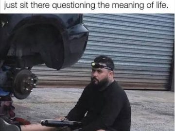 Man sitting in front of car, pondering DIY project gone long