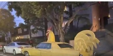 Yellow car with rooster design offering a dark humor twist.