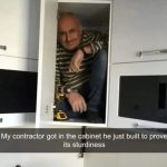 Contractor inside a cabinet proving its sturdiness with a smile.