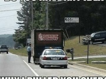 Police car behind Dunkin Donuts truck with a traffic stop joke.