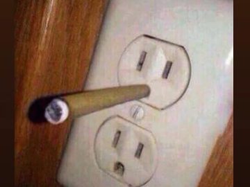 Cigarette in an outlet with the caption "No wonder my electricity bill is so high."
