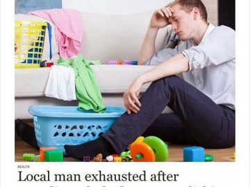 Exhausted man surrounded by laundry and toys after a lazy day.