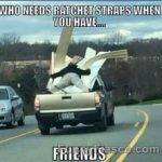 Guy holding lumber in a truck with no straps, showing an epic fail.