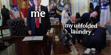 Person in office ignoring a pile of unfolded laundry labeled "me" and "my unfolded laundry."