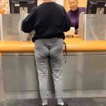 Person in tight pants at bank, relatable tight budget humor.