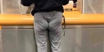 Person in tight pants at bank, relatable tight budget humor.