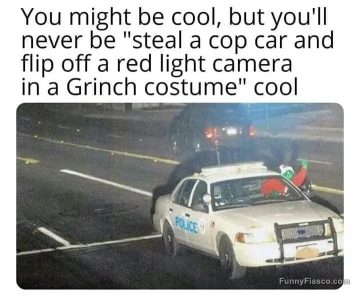 Grinch in police car flips off red light camera humor meme