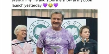 Dad wearing a purple tie-dye shirt that says "Hannah's Dad" at a book launch.