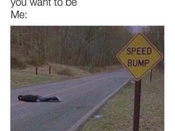 Person lying on road as a speed bump next to sign, dark humor
