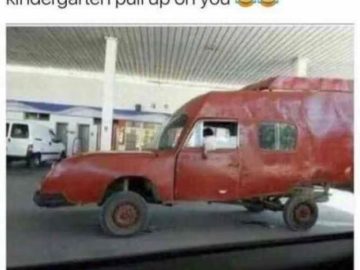 Wacky red car resembling a child’s drawing at a gas station.