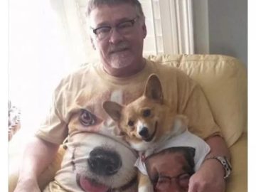 Man and dog wearing matching T-shirts with each other's faces.