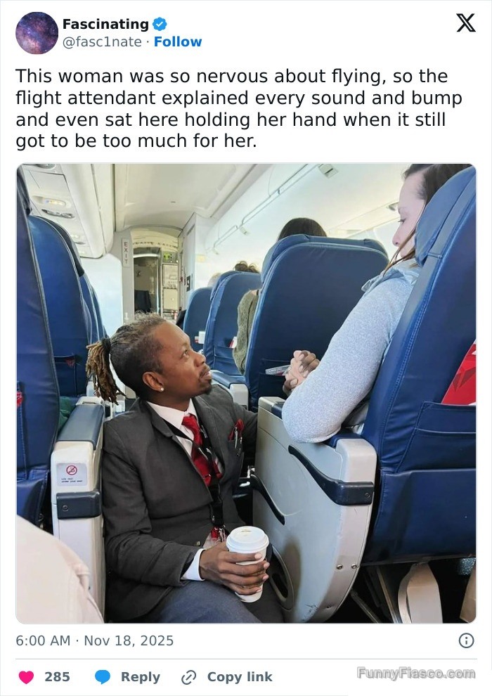 Flight attendant kneeling and comforting a nervous passenger.