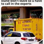 Yellow truck with Hoe Removal Service sign for a funny meme.