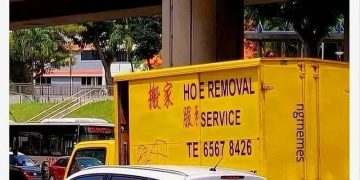Yellow truck with Hoe Removal Service sign for a funny meme.