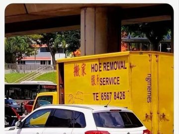 Yellow truck with Hoe Removal Service sign for a funny meme.