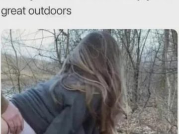 Woman enjoying a humorous moment in the woods.