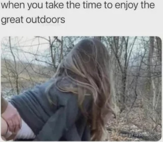 Woman enjoying a humorous moment in the woods.