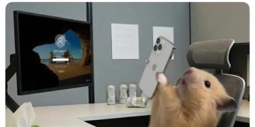 Hamster in office chair on phone, feeling overworked and underpaid.