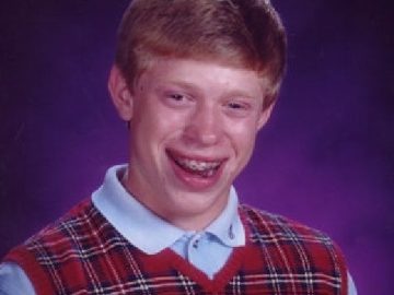 Teen in school photo with awkward smile and sweater vest