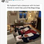 Three friends in sleeping bags with pizza, watching TV.