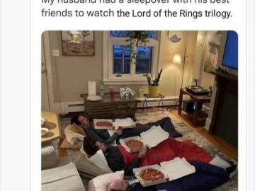 Three friends in sleeping bags with pizza, watching TV.