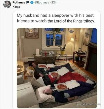 Three friends in sleeping bags with pizza, watching TV.
