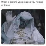Statue raising hand like blessing a car letting you cross